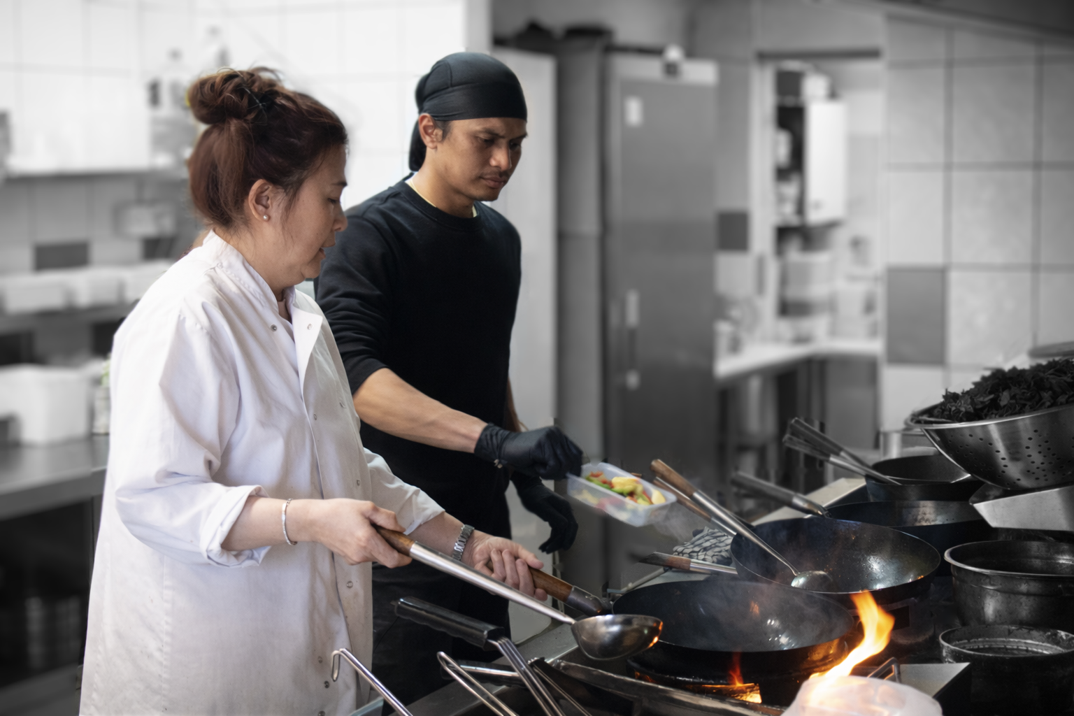 Queenie and chef cooking together at the wok